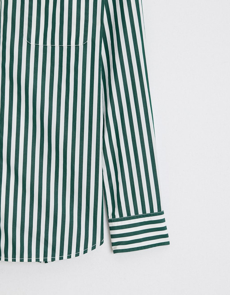 Close-up of a green and white striped shirt on a light gray background