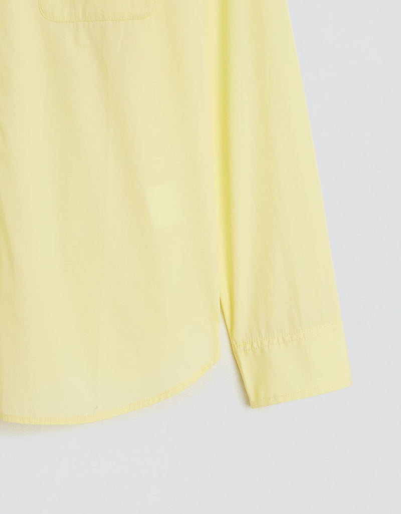 Sleeve of a yellow shirt on a light gray background