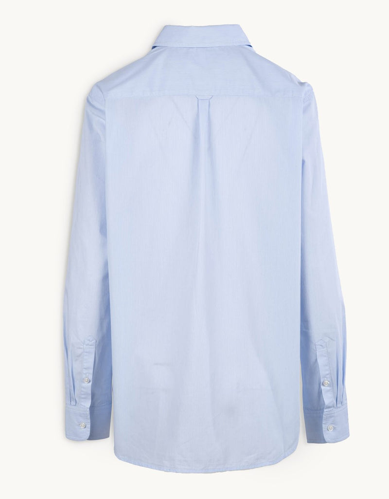 Back view of a light blue shirt on a white background
