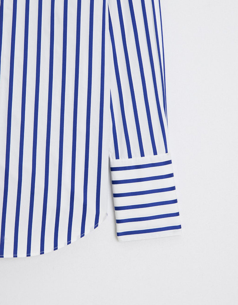 Close-up of a cobalt blue and white striped shirt on a light gray background
