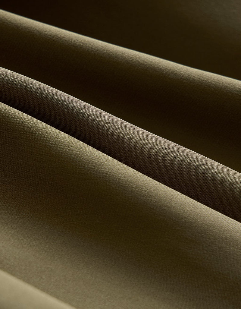Close-up of olive silk fabric with a soft texture