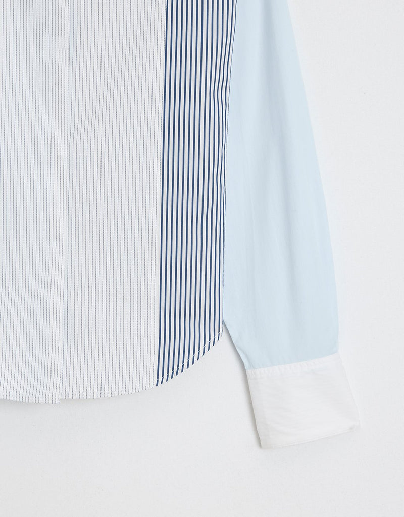 Close-up of a striped colorblock tuxedo button down shirt with a plain background