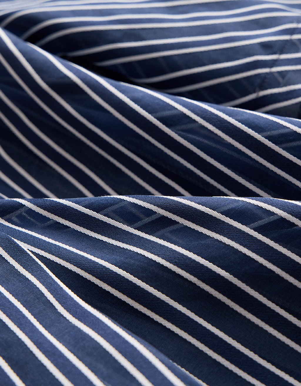 Close-up of navy and white striped organza fabric