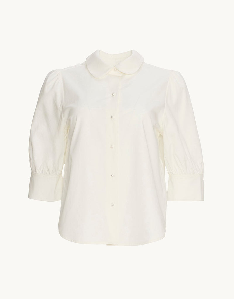White puff sleeve button down shirt on a plain background