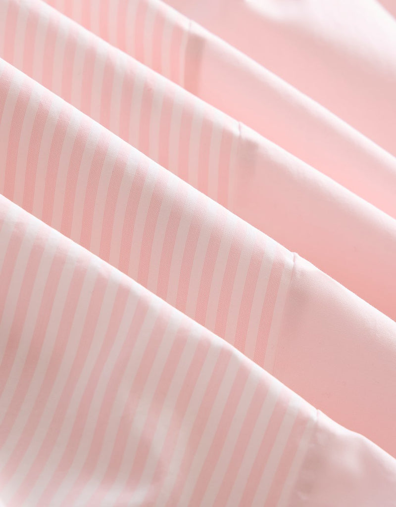 Close-up of light pink fabric with white stripes