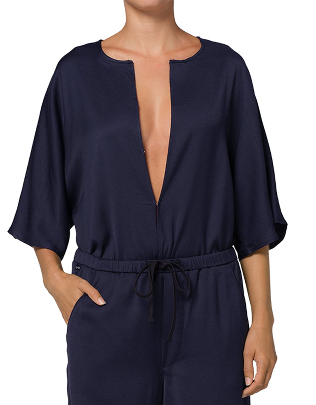 Navy blue jumpsuit with a deep neckline on a white background