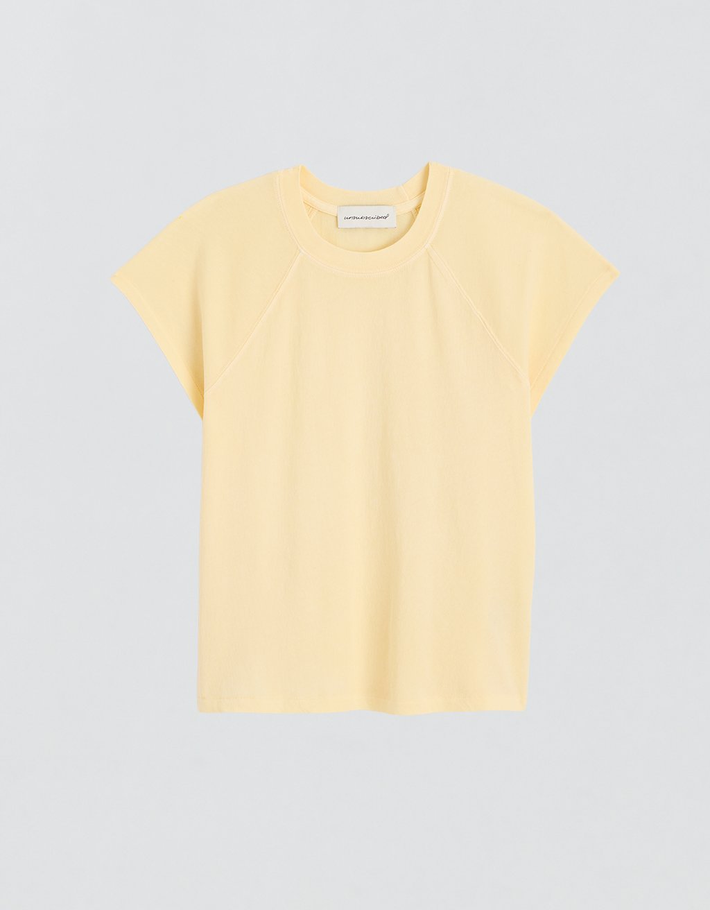 Yellow raglan t-shirt on a light gray background