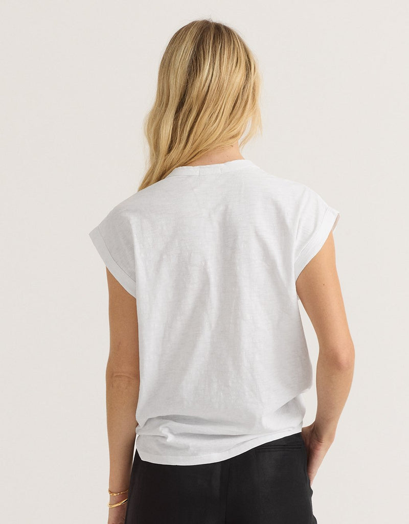 Back view of a woman wearing a white t-shirt on a light gray background