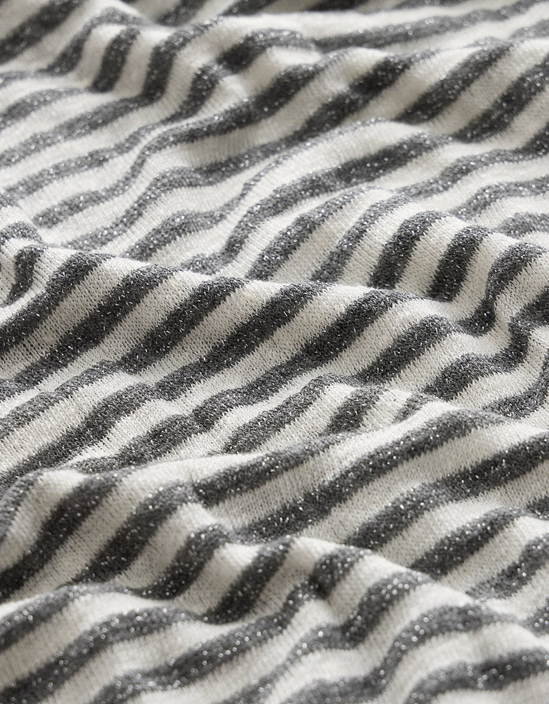 Close-up of fabric with stripe pattern and metallic details