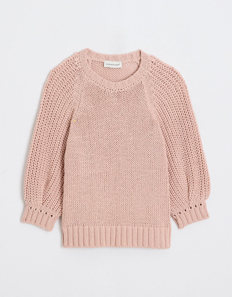 Pink puff sleeve sweater on a light gray background