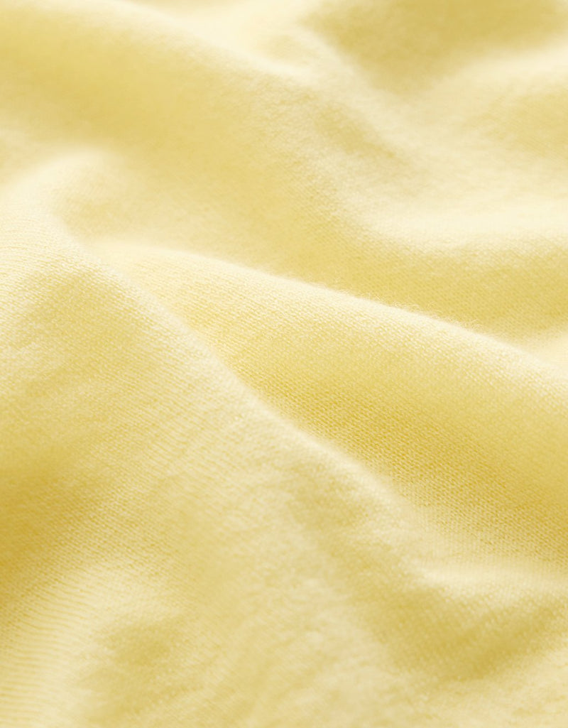Close-up of a light yellow cashmere fabric texture