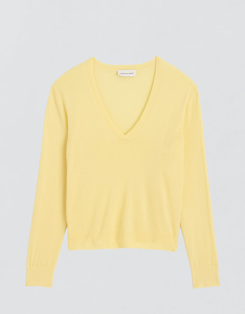 Yellow cashmere V-neck sweater on a light gray background