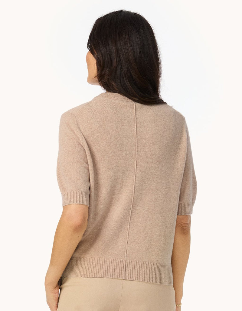 Back view of a woman wearing a camel cashmere sweater tee with back seam and ribbed trim details on a white background