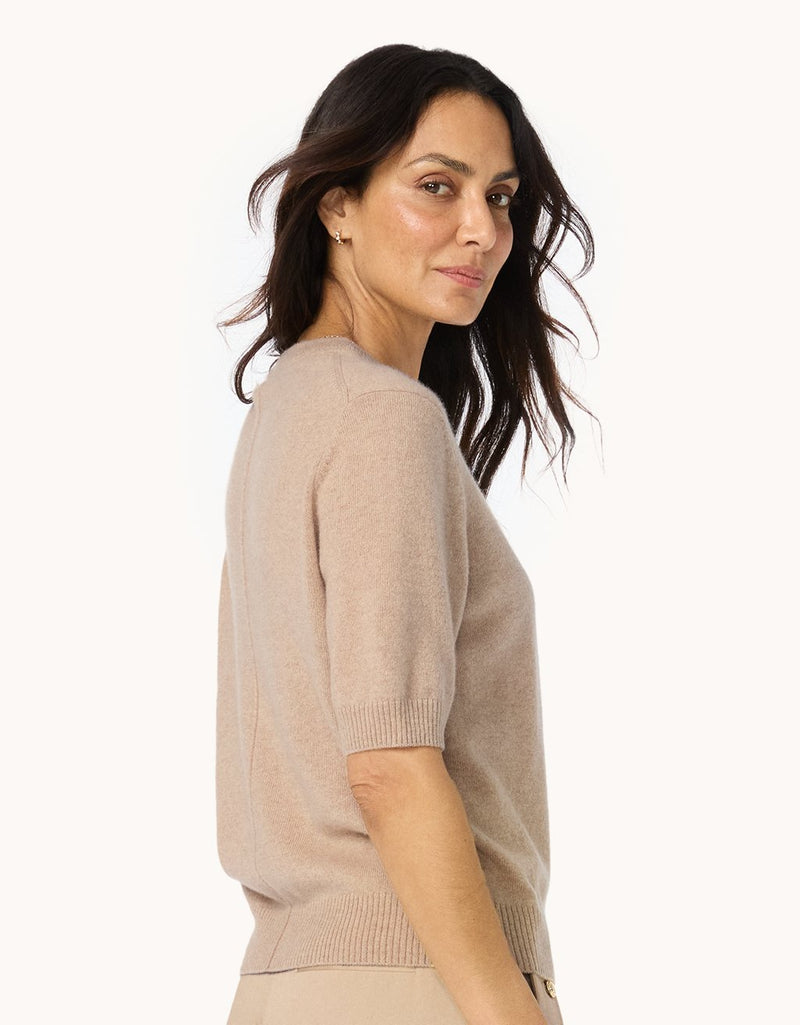 Profile of a woman wearing a camel cashmere sweater tee on a white background