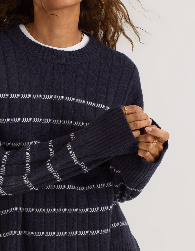 Navy blue stripe ribbed cashmere sweater worn by a person on a light background