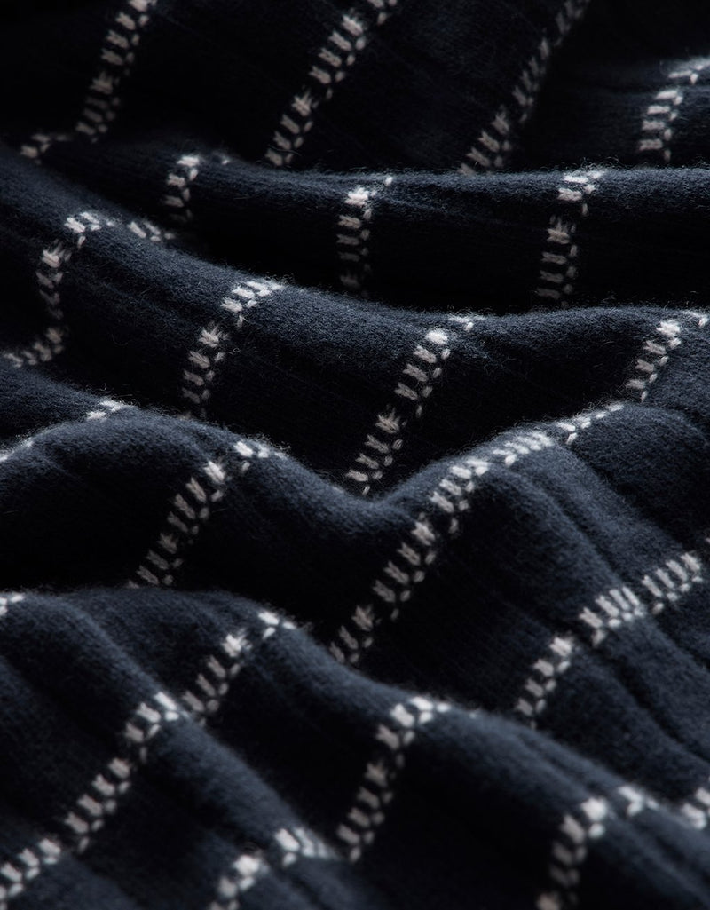 Close-up of navy cashmere fabric with white stripe detail