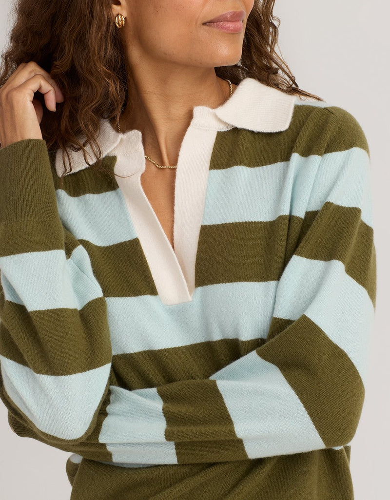 Close-up of a woman wearing a green and light blue striped cashmere polo sweater with a white collar
