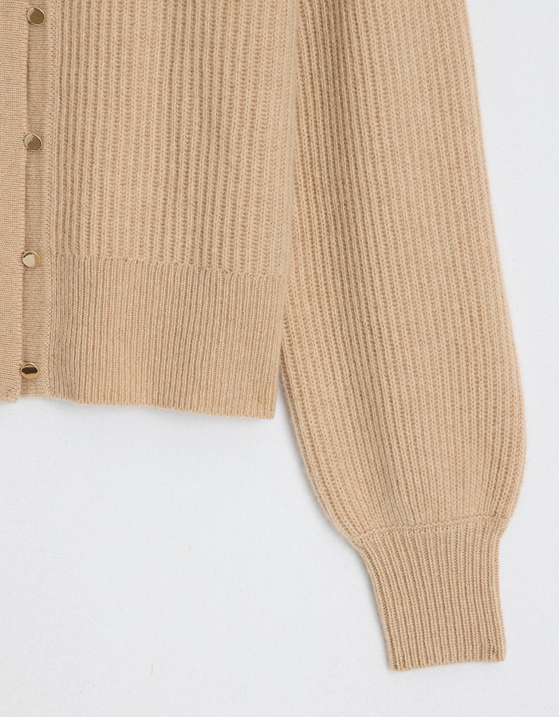 Close up detail of a camel puff sleeve cashmere cardigan on a light gray background