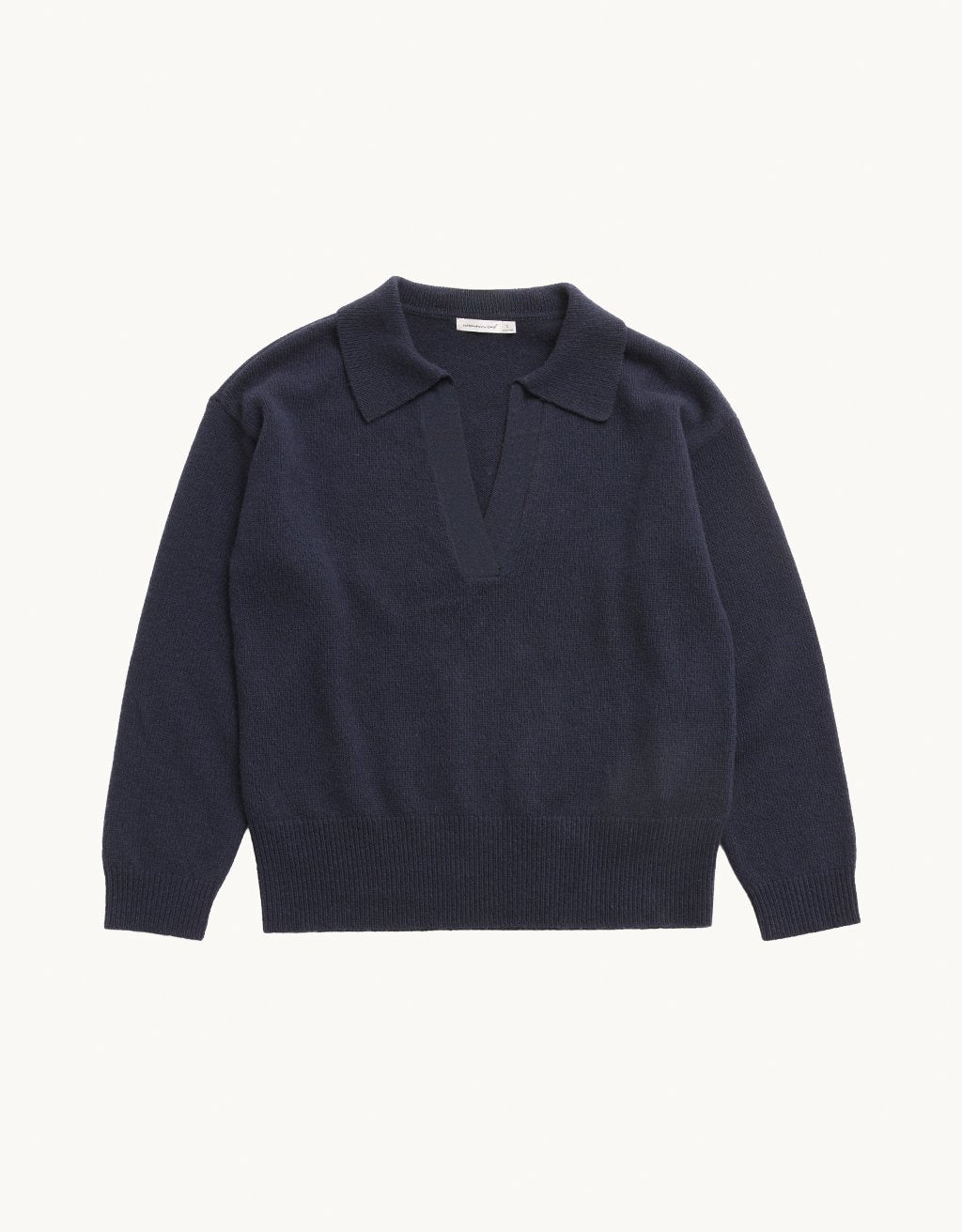Navy cashmere polo sweater on a light gray background