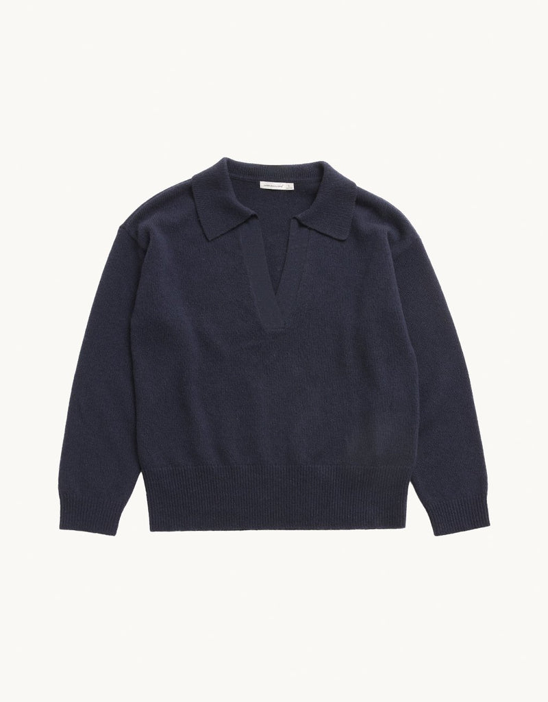 Navy cashmere polo sweater on a light gray background