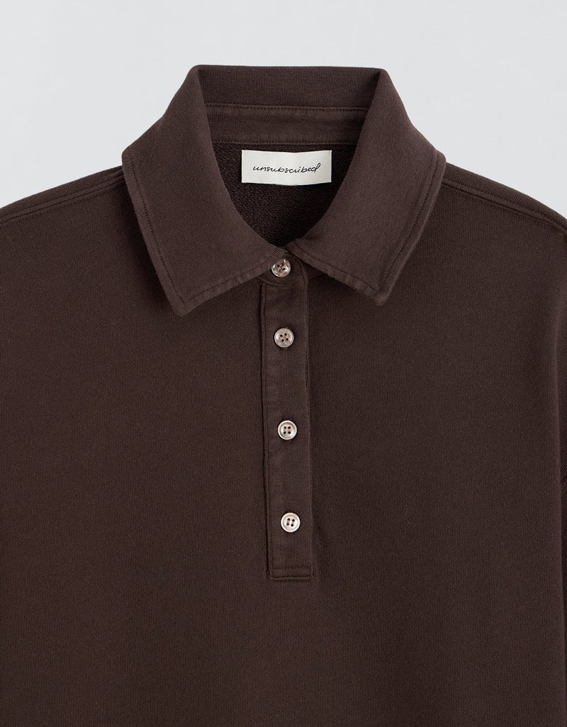 Dark brown sweatshirt sleeve on a light gray background