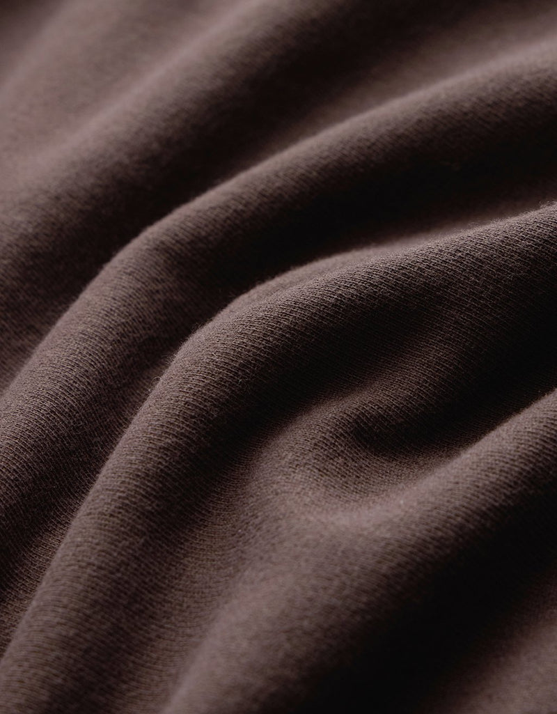 Close-up of dark brown fabric with folds