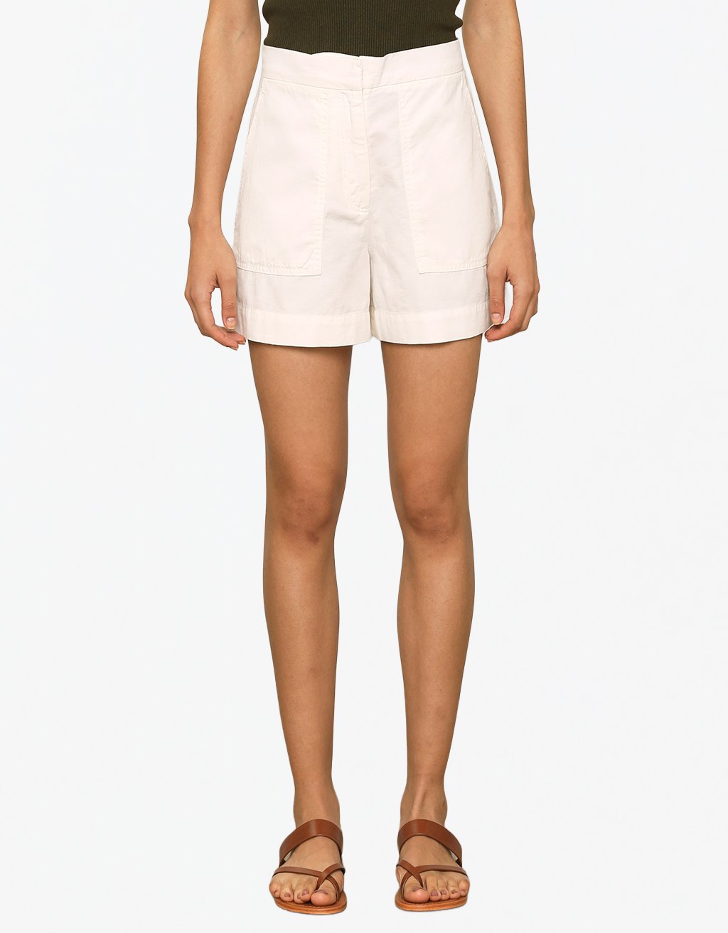 Person wearing ivory shorts on a plain background