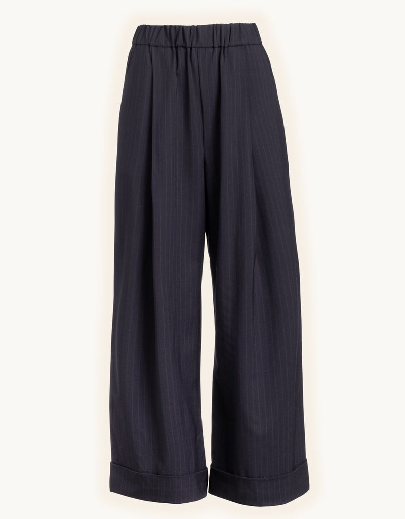 Navy pinstripe wide-leg pants on a light gray background