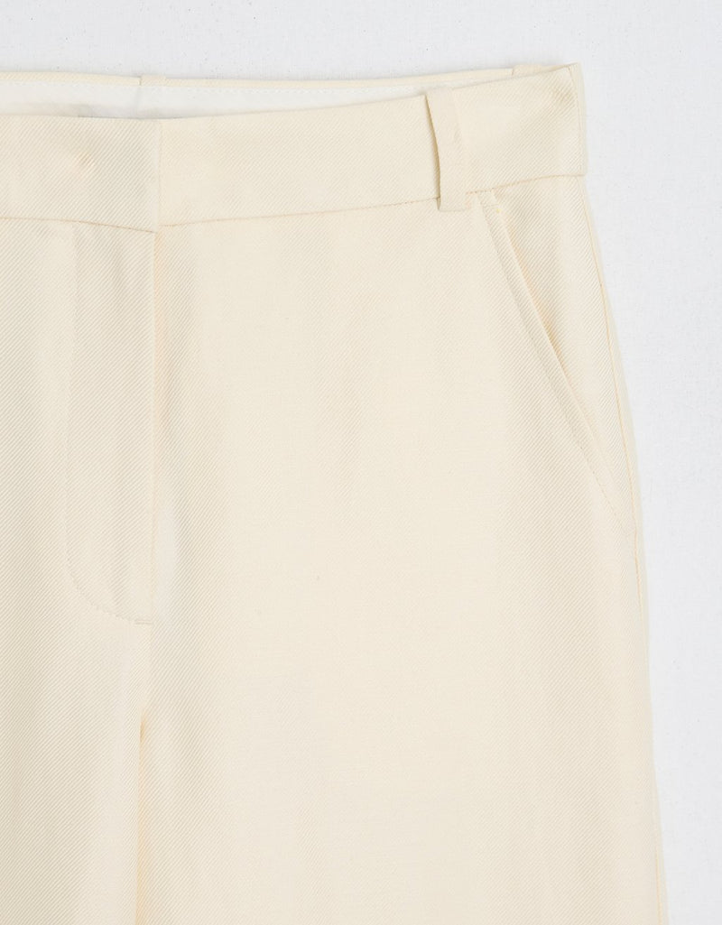 Cream pants with belt loop waistband and pockets on a white background