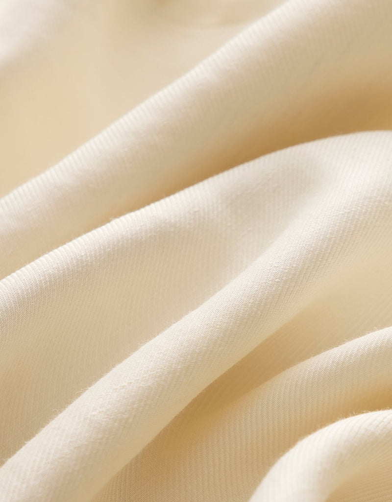 Close-up of cream fabric with soft texture