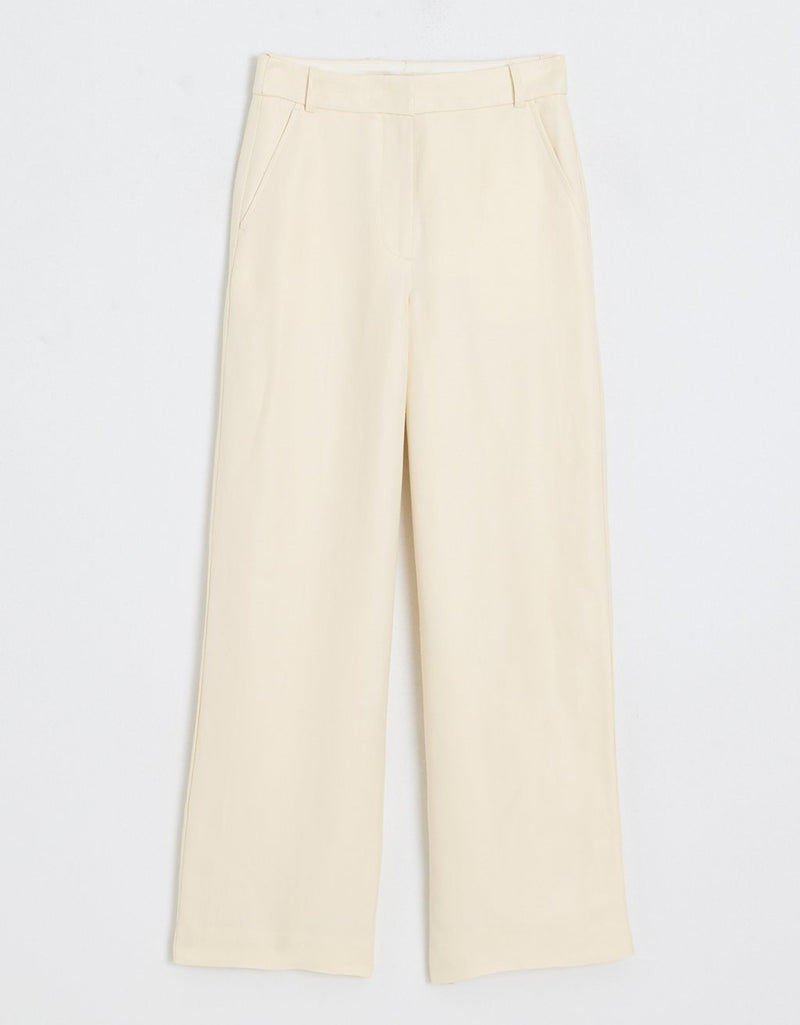 Cream wide leg pants on a light gray background