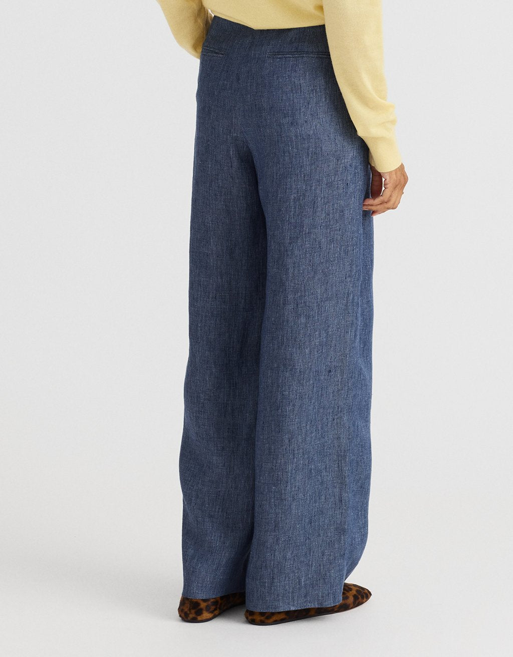 Person wearing blue wide-leg hemp pants on a white background