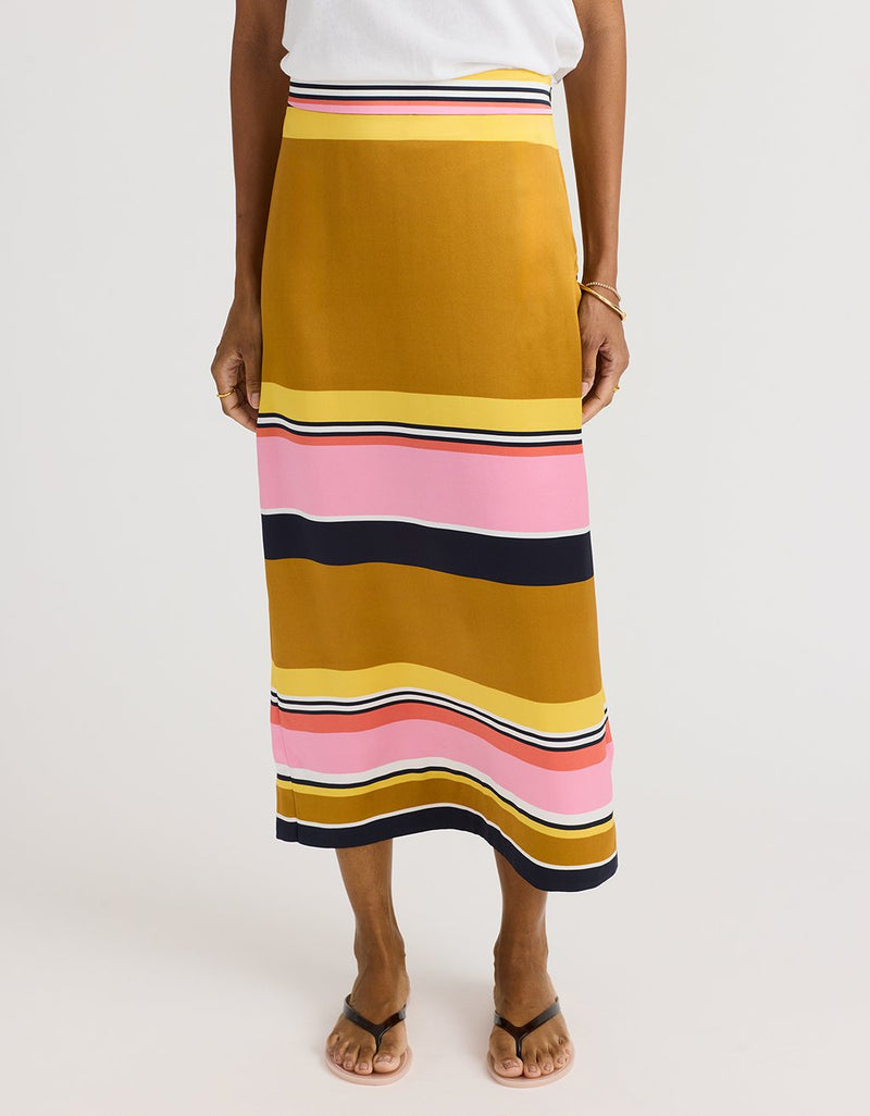 Person wearing a colorful striped skirt on a white background