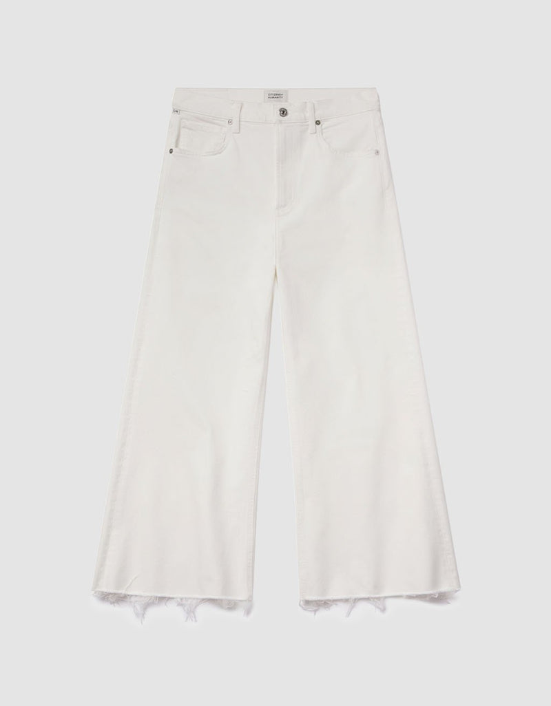 White wide-leg jeans with frayed hems on a light gray background