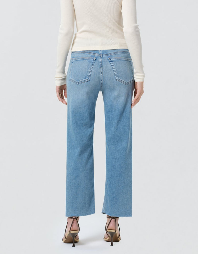 Light blue jeans worn by a person on a white background
