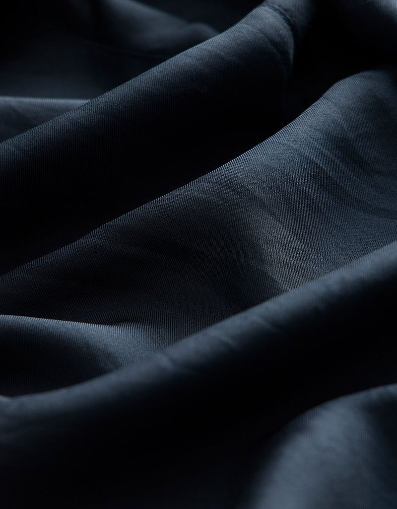Close-up of navy silk fabric with folds