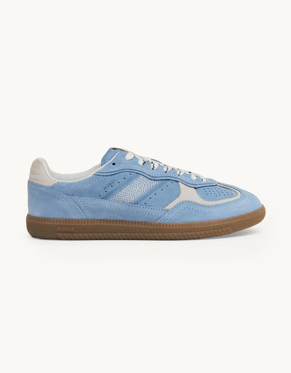 Profile view of a cornflower blue suede sneaker with white accents and a rubber sole on a light gray background