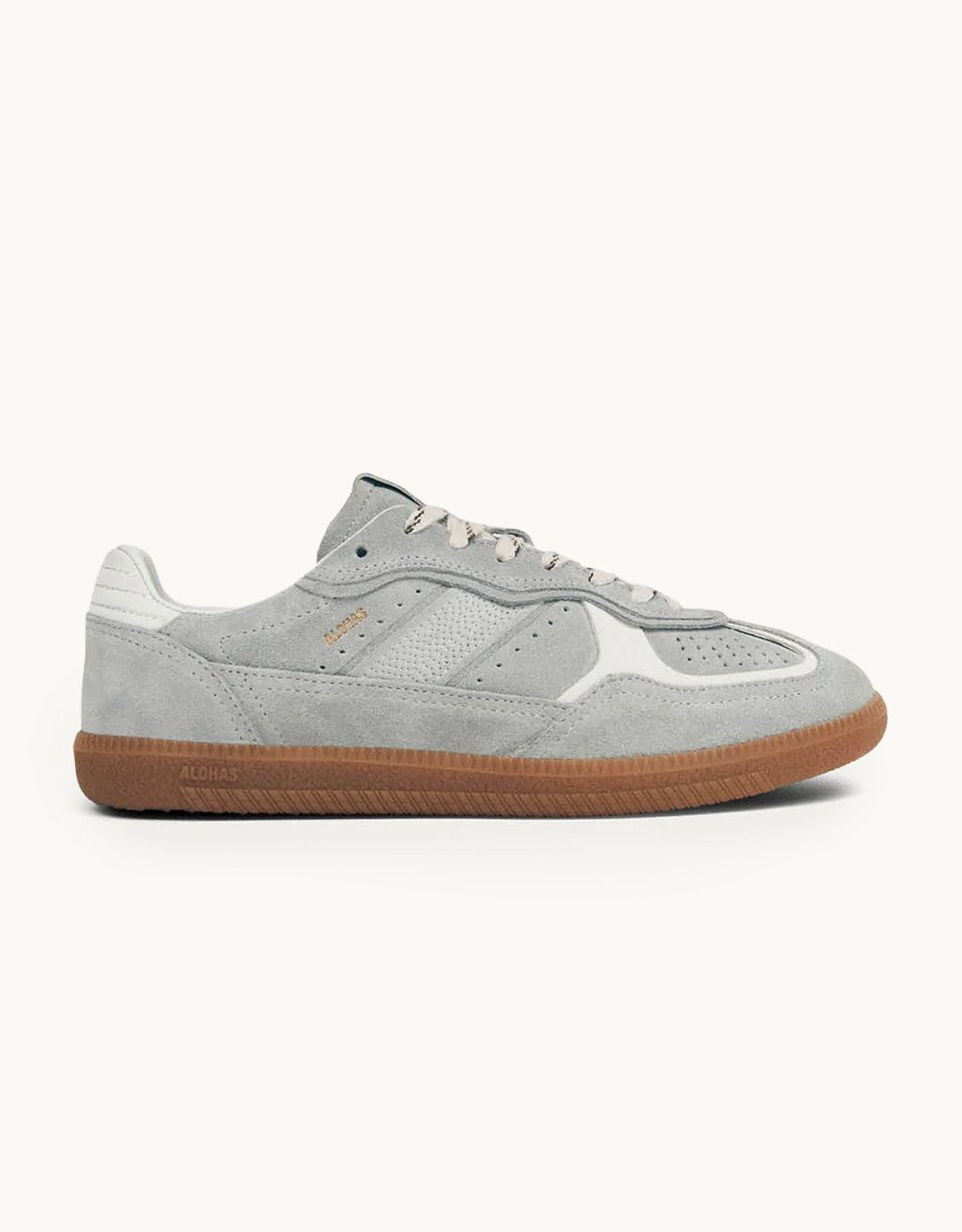 Profile view of a gray leather low top sneaker with white details and rubber sole on a light gray background