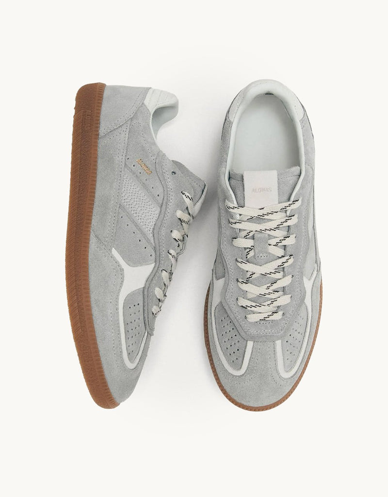 Top and side views of a pair of gray sneakers with white details and rubber soles on a background