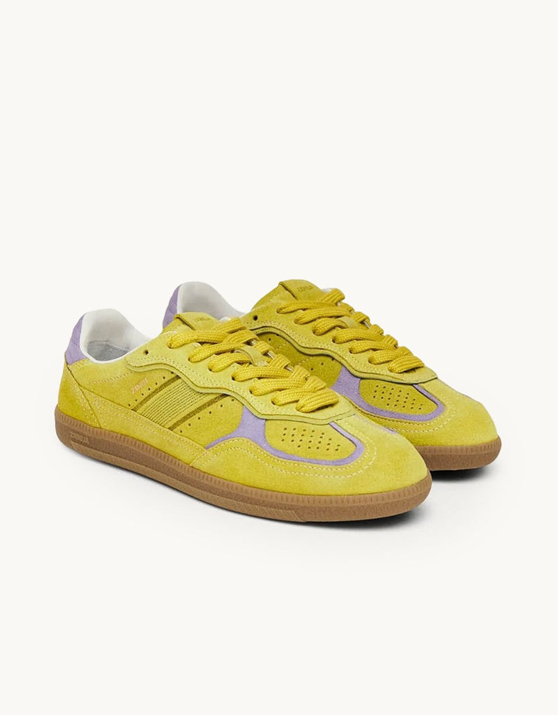 Low top acid green leather sneakers with purple accents on a light gray background