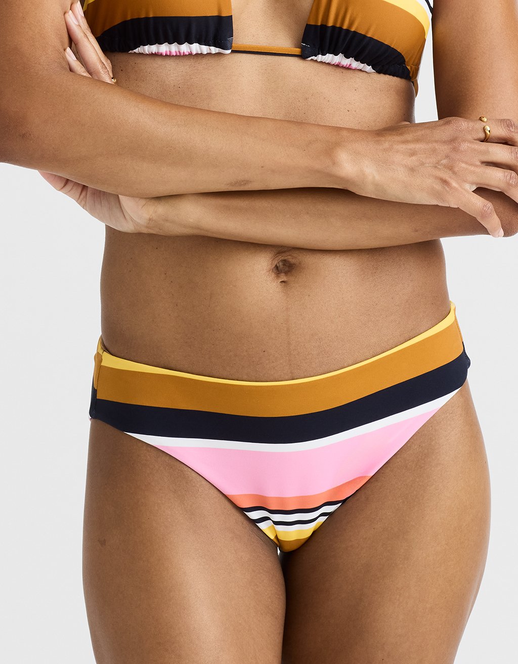 Person wearing a colorful striped bikini against a white background