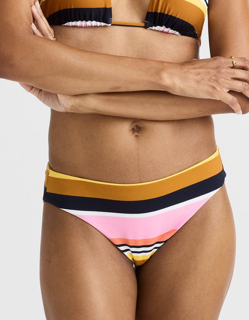 Person wearing a colorful striped bikini against a white background