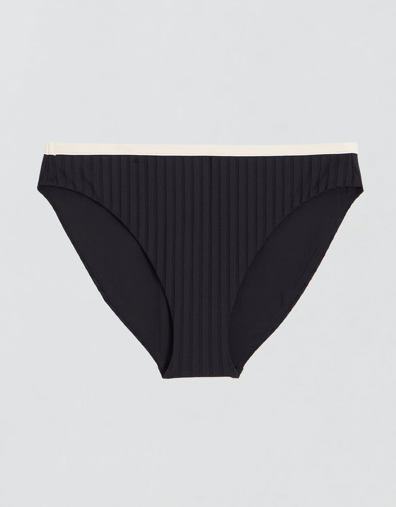 Black ribbed bikini bottoms with contrast ivory waistband on a light gray background