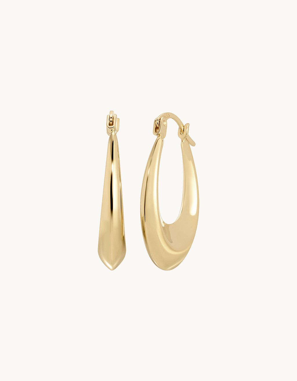 Gold hoop earrings on a light gray background