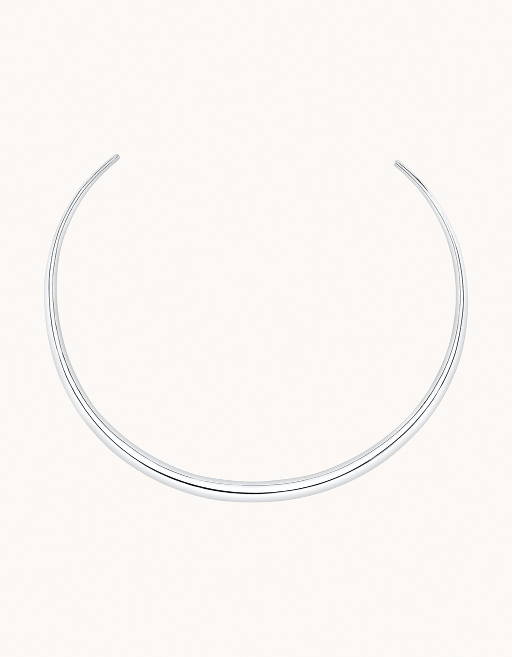 Silver choker necklace on a plain background
