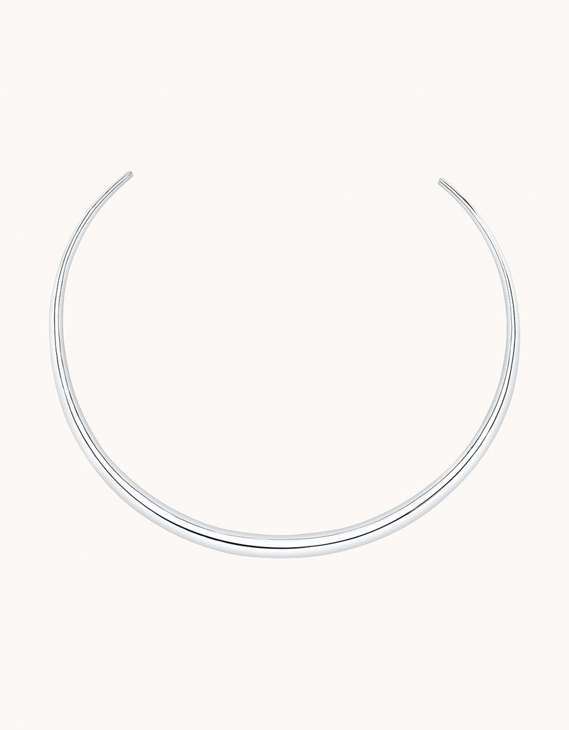 Silver choker necklace on a plain background