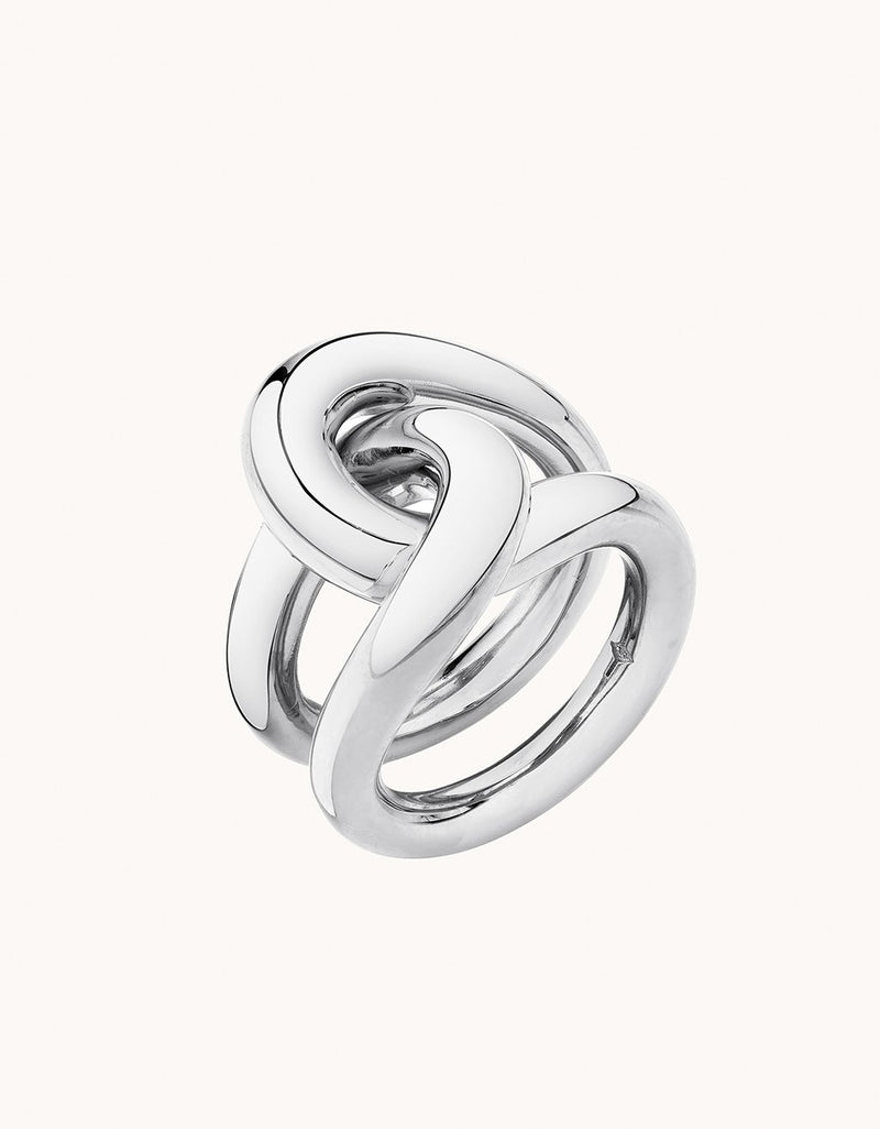 Silver ring with a unique link design on a plain background