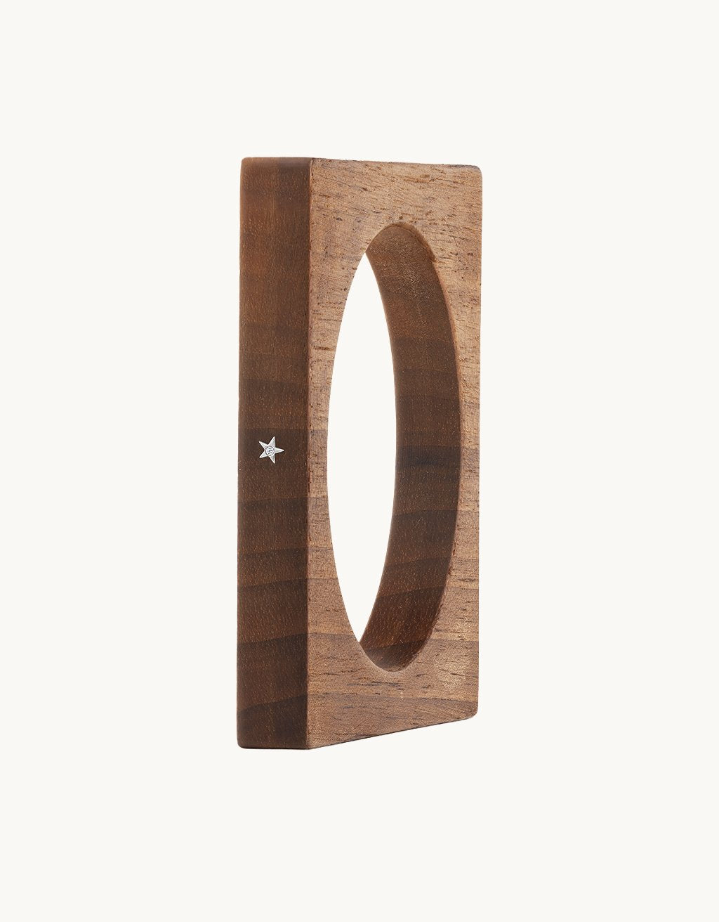 Square wooden bracelet with a star detail on a light gray background