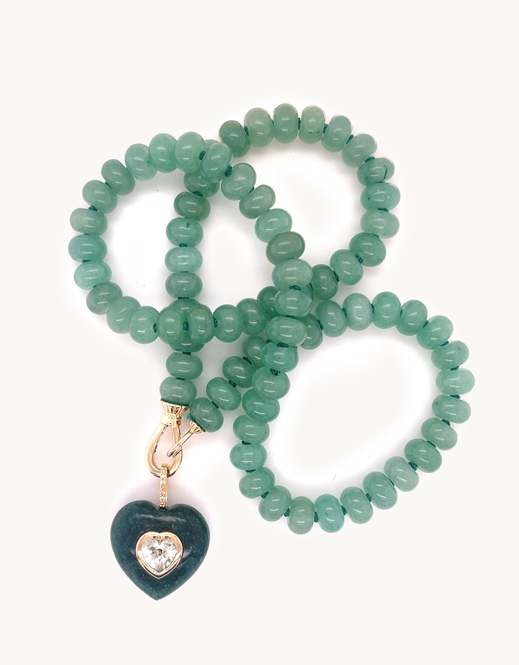 Green Aventurine gemstone with a single green amethyst center stone and diamond bail on green bead chain against a light gray background