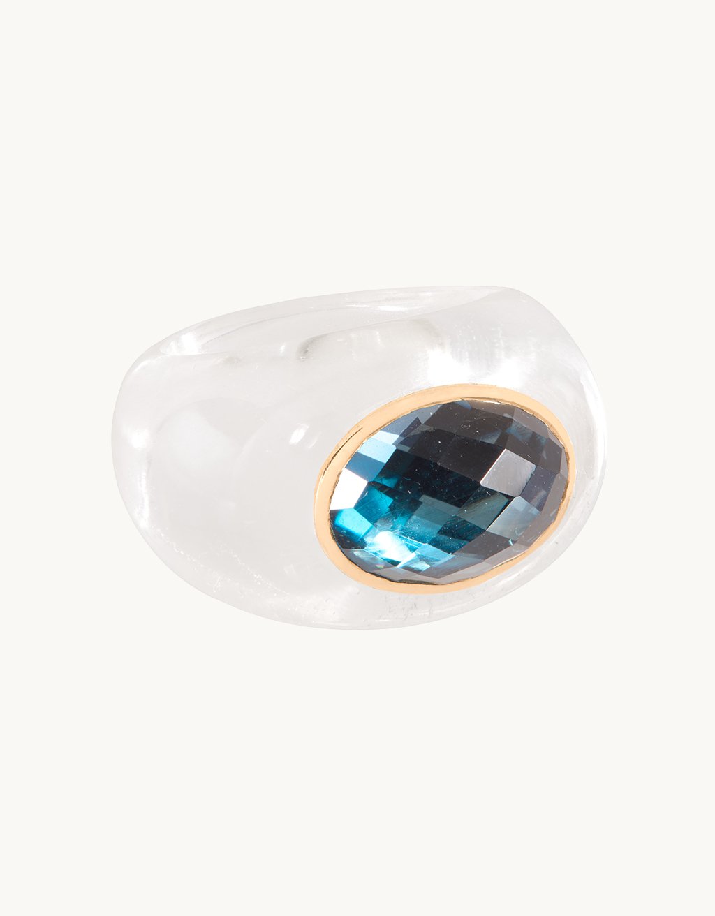 Crystal ring features a rose-cut blue topaz stone on a light gray background